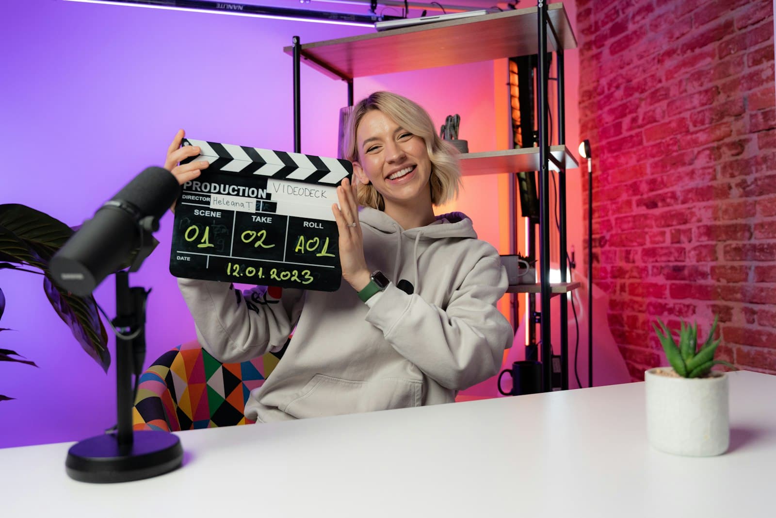 Creator with clapperboard and ring light