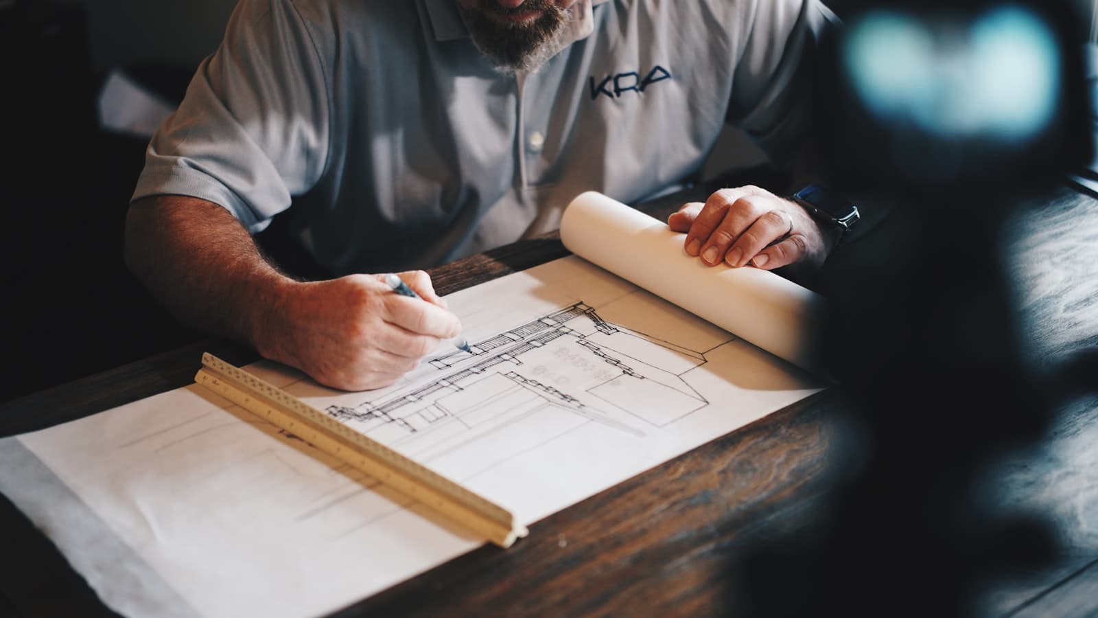 Architect drawing a building blueprint